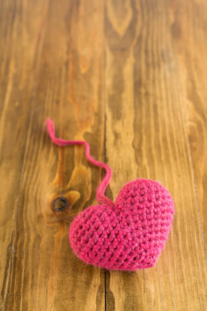 istock One crocheted heart on a wooden table 831700996