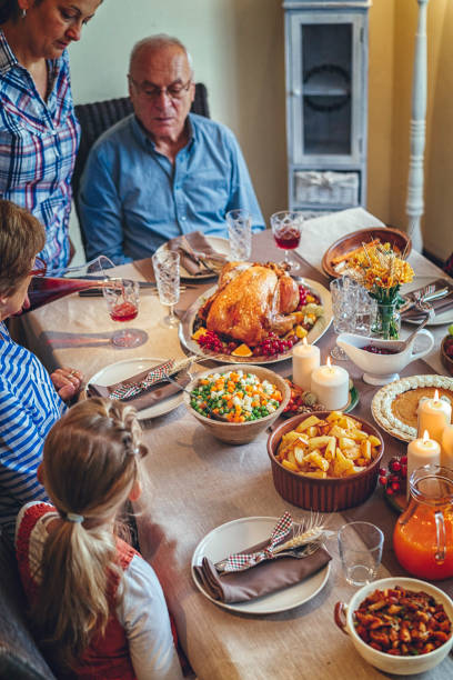 istock Family Having Traditional Holiday Stuffed Turkey Dinner 831703908