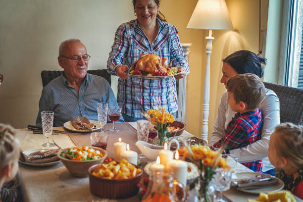 istock Family Having Traditional Holiday Stuffed Turkey Dinner 831703918