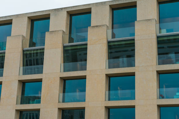 istock modern office facade with big blue windows in detailed view 831704388