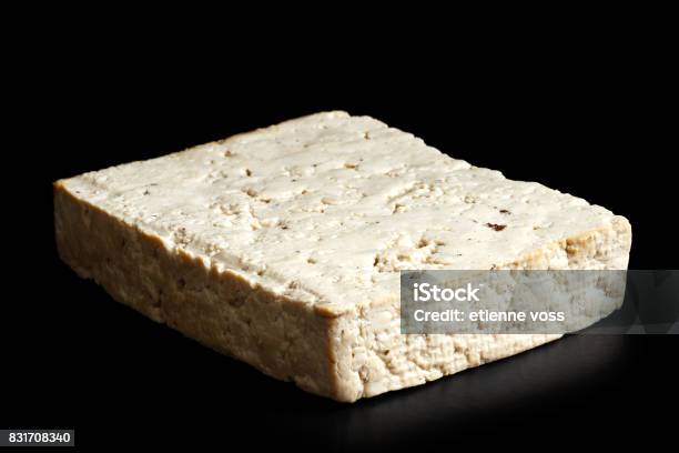 Single Block Of Lightly Smoked Tofu Isolated On Black Stock Photo - Download Image Now