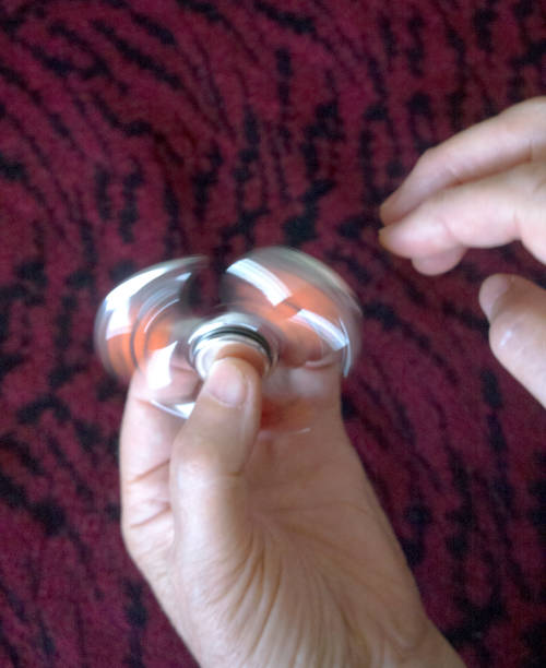 istock Spinners in hands at the grandmother. 831708736