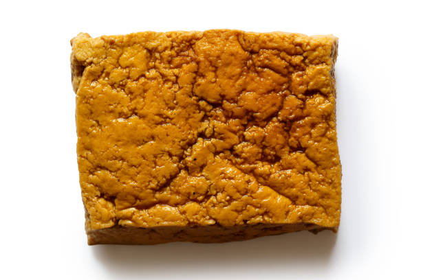 istock Single block of smoked tofu isolated on white from above. 831712694
