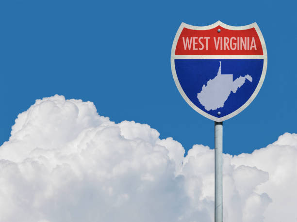 istock Highway sign for Interstate road in West Virginia with map in front of clouds 831721242