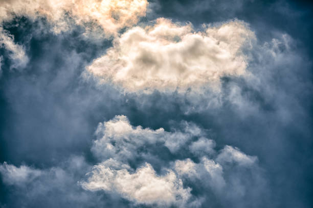 istock Blue sky with yellow and white clouds closeup 831731974