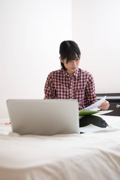 istock young woman studying on the bed 831732196