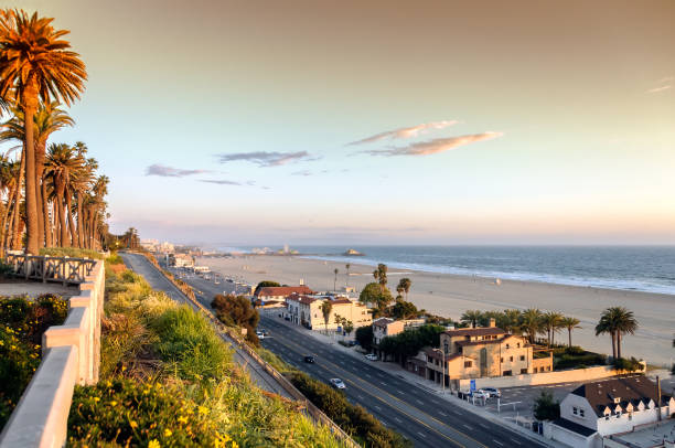 View of Pacific Coast highway at Santa Monica, California View of Pacific Coast highway and Santa Monica beach, ocean front homes and the Pacific ocean, as seen from Palisades Park. pacific coast stock pictures, royalty-free photos & images