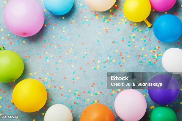 Colorful Balloons And Confetti On Turquoise Table Top View Birthday Holiday Or Party Background Flat Lay Style Stock Photo - Download Image Now
