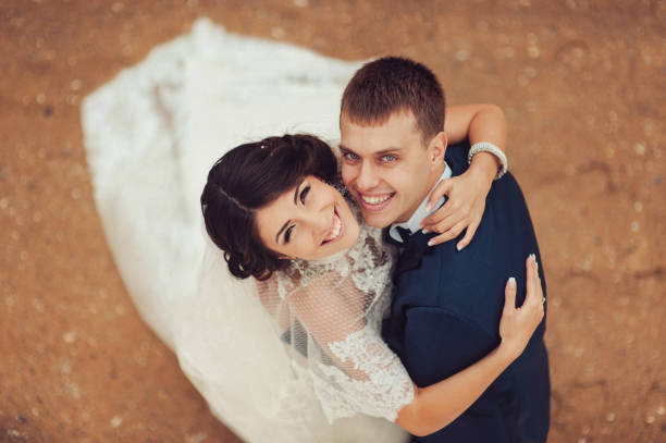 istock Beautiful wedding couple on a walk near water 831736236