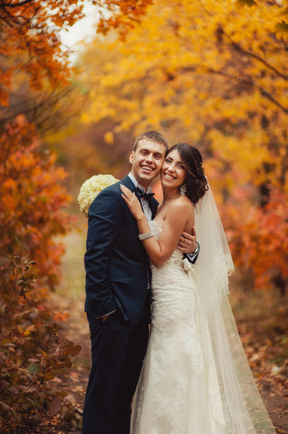 istock Wedding couple on a walk in the autumn park 831736332