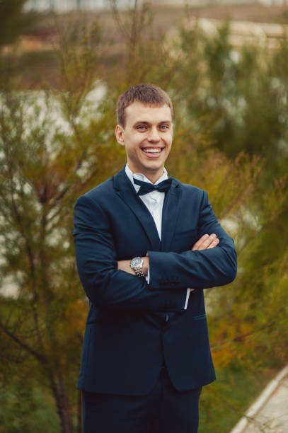 istock Groom in a suit and a bow tie for a walk 831736554