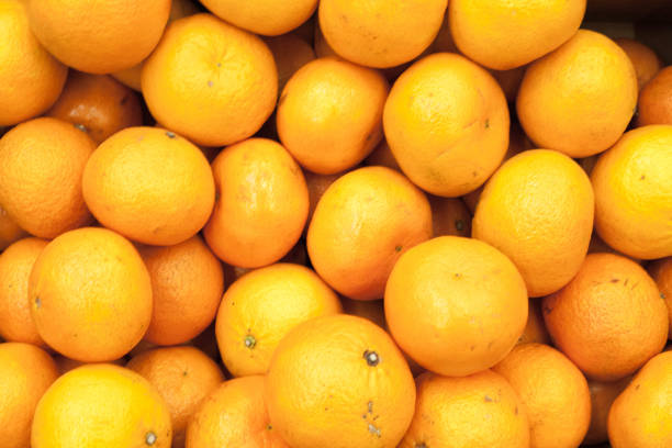 istock Bunch of fresh mandarin oranges on market 831739310