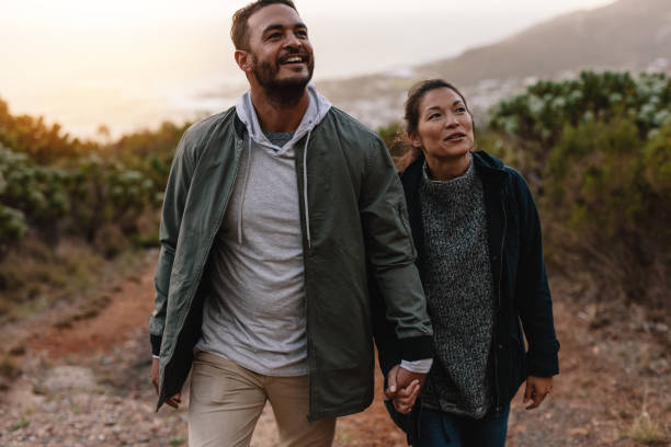 istock Young man on a hiking trip with his girlfriend 831739908