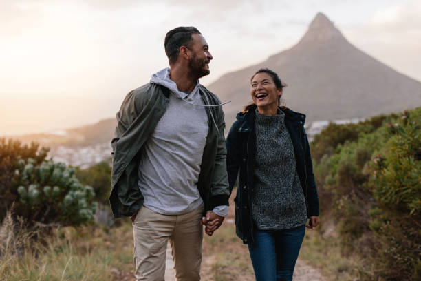 istock Young couple walking together in countryside 831739972