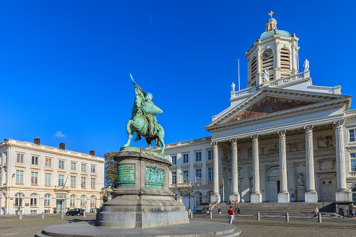 The Place Royale is an historic square of Brussels. It is bordered by the Church of Saint Jacques-sur-Coudenberg, consecrated in 1787, and some museums. At the center stands the statue of Godfrey of Bouillon on horseback, sculpted by Eugène Simonis in 1848. People in the square.