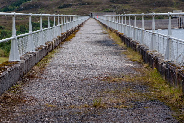 istock Walking path on top of hydroelectric dam wall in Scotland 831740724