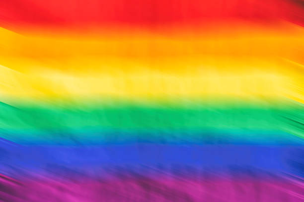 Motion blurred picture of a gay rainbow flag during pride parade. Concept of LGBT rights. stock photo