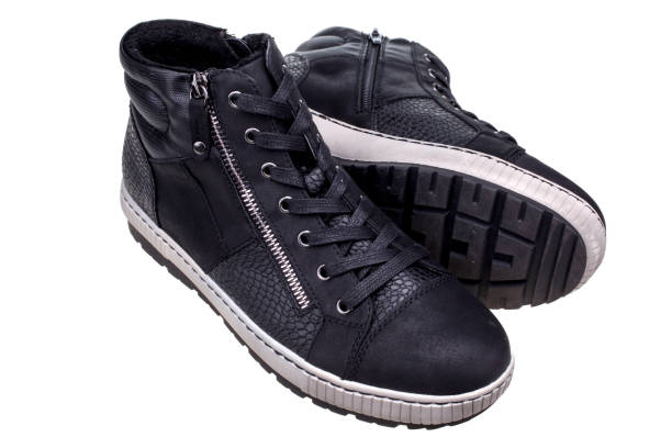 Pair of fake leather black high sneakers. stock photo