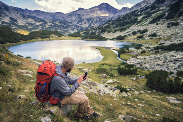 istock Traveler hiking in mountains and enjoying a view from above 831744892