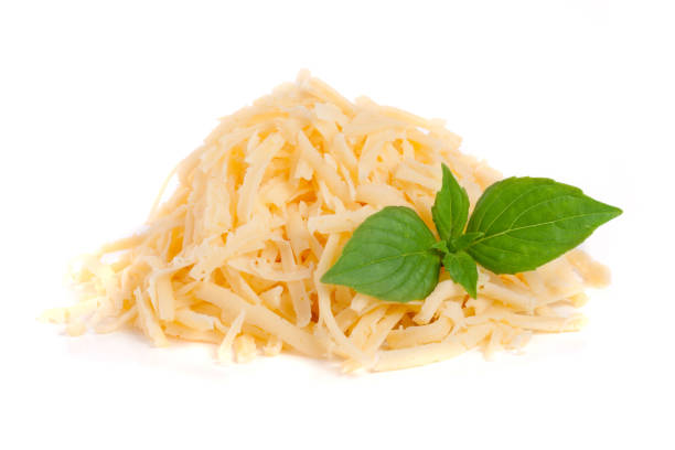 istock Heap of grated cheese with basil leaves isolated on white background 831748140