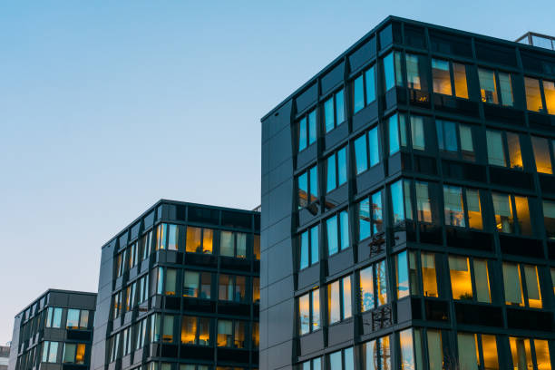 istock Row of office blocks illuminated at dusk 831751430