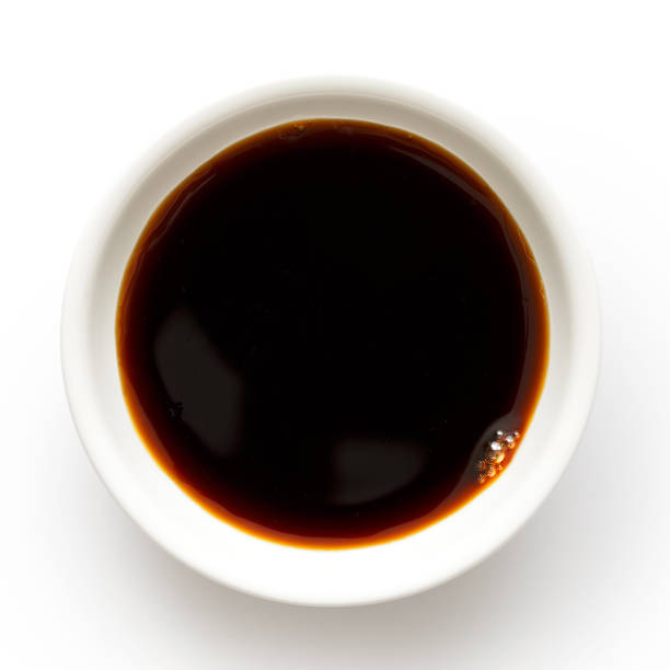 istock Soya sauce in white ceramic bowl isolated on white from above. 831756576