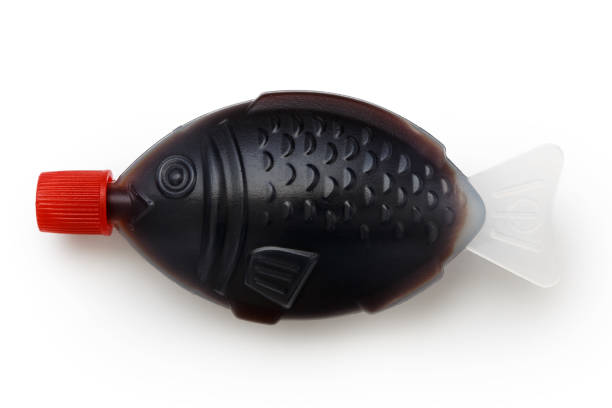 Fish shaped take away soya sauce isolated on white from above.