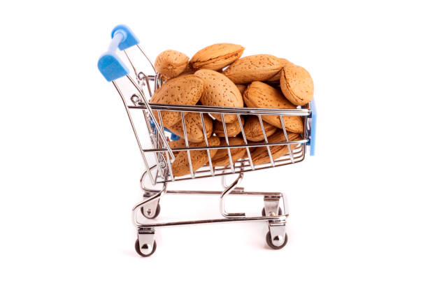 istock Shopping cart with almonds isolated on white background 831757080