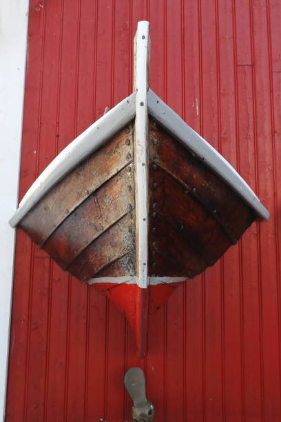 Eccentric ornate on rorbu-traditional fishing hut exterior. Reine-Moskenes-Lofoten-Nordland-Norway. 0272 Eccentrically ornate-red painted facade of rorbu-traditional seasonal fishing hut now for tourist use beside the European E10 road passing just off the village. Reine-Moskenes-Lofoten-Nordland-Norway. hull house stock pictures, royalty-free photos & images