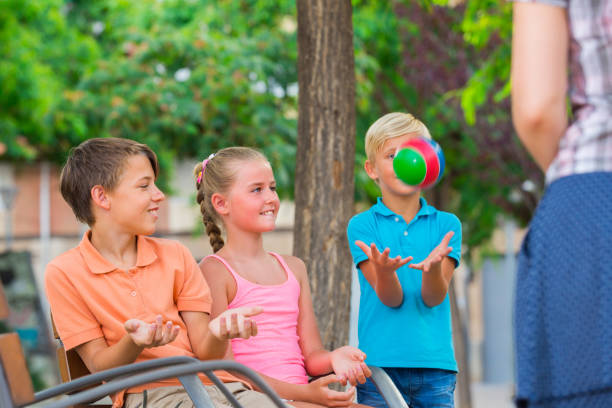 istock Cheerful children are playing with ball 831770246