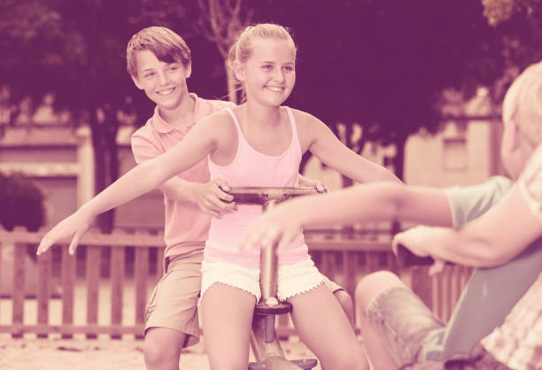 istock Cheerful children are teetering on the swing 831770326
