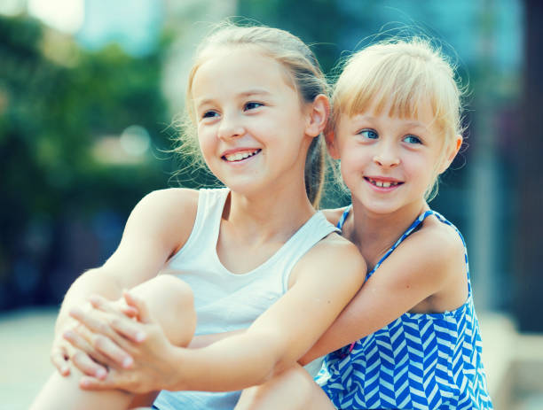 istock Two small happy sisters outdoors 831777744
