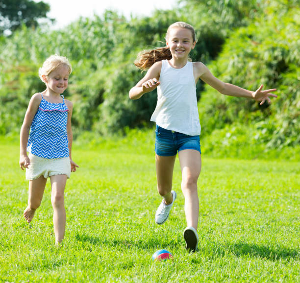 istock Two girls playing with ball outdoors 831777766