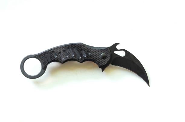istock Tactical knife in the form of a claw. Knife on a white background. 831783272