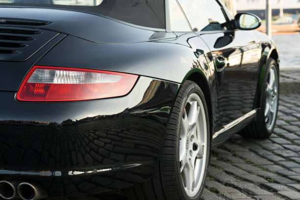 Black Porsche 911 parked during the event with Magnus Walker on the Fish Market Hamburg Hamburg, Germany - August 8. 2017: Magnus Walker - Car collector / builder of classic Porsches was in Hamburg: Drivers with their cars were invited to come to the fish market and have a good time. park designer label stock pictures, royalty-free photos & images