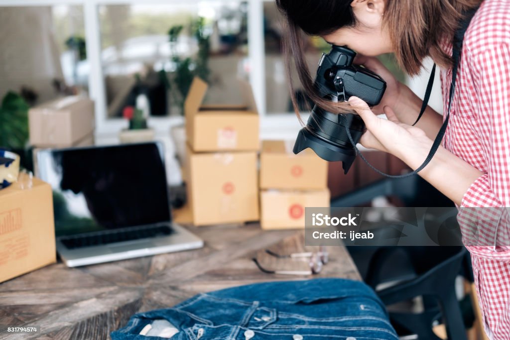 Online seller take a photo of product for upload to website online shop. Online seller owner take a photo of product for upload to website online shop. Online Shop, Online Selling , Online Shopping and e-Commerce concept. Merchandise Stock Photo