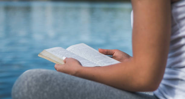 istock Woman relaxes on lake, reads a book 831798750