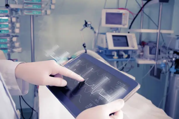 Photo of Doctor with advanced equipment in hospital ward