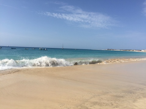 Waves breaking on a white sand beach