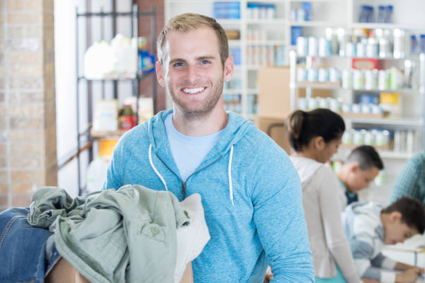 istock Handsome man donates clothing to community 831814678