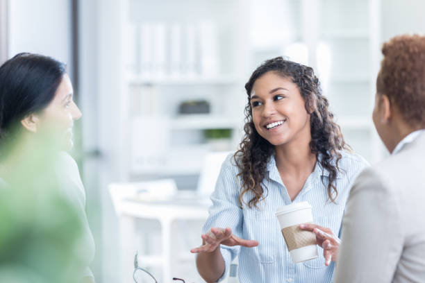 istock Three businesswomen take a coffee break 831814970