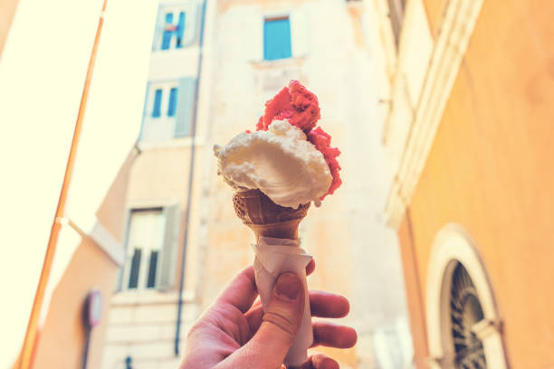 istock Man holding a cone with creamy Italian ice-cream 831815288