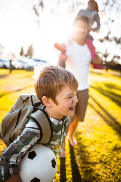 istock daddy take the son to the school 831821474