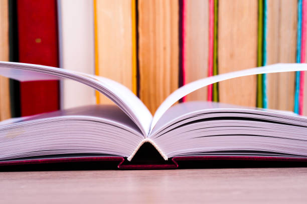 istock Open book, hardback books on bright colorful background. 831821480