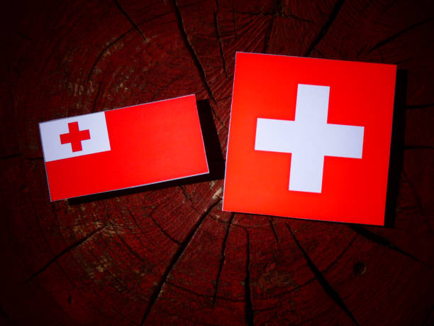 istock Tonga flag with Swiss flag on a tree stump isolated 831821760