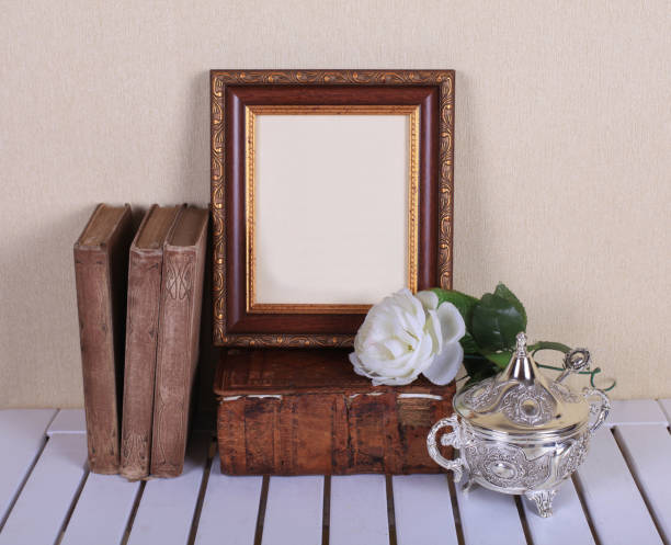 istock Wood frame with old books on table 831822144