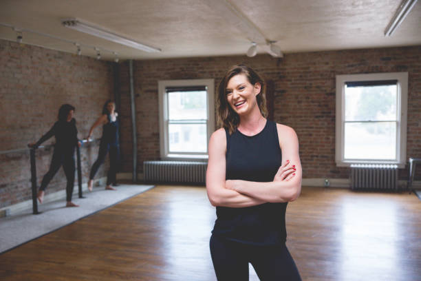 istock Woman Posing in Barre Studio with Others in Background 831822218