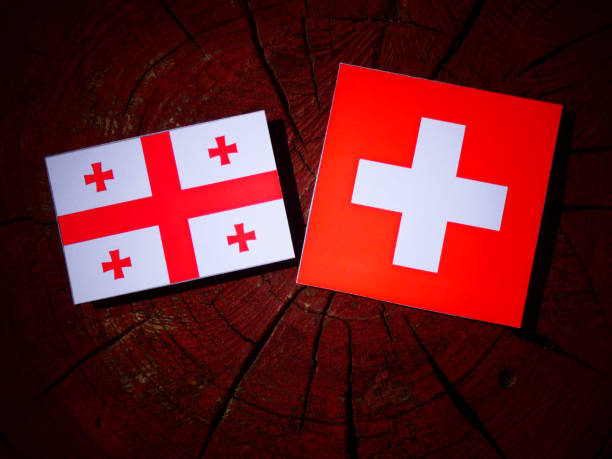 istock Georgian flag with Swiss flag on a tree stump isolated 831829074