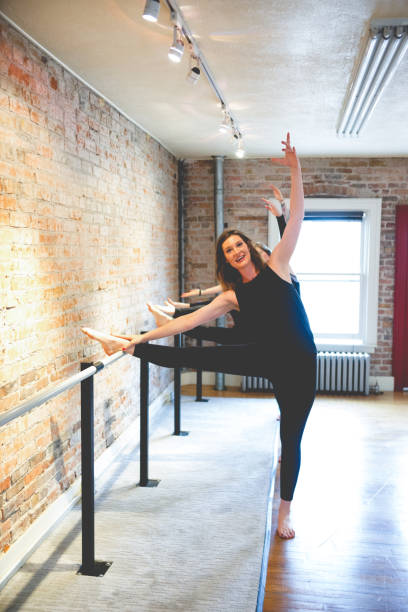 istock Three Women Doing Body Stretch on Barre 831829824