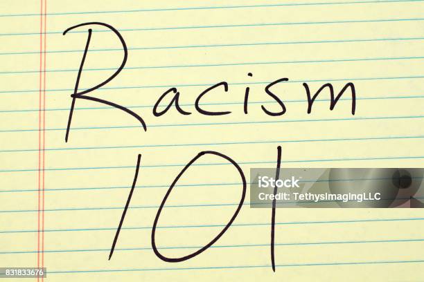 Racism 101 On A Yellow Legal Pad Stock Photo - Download Image Now - Racism, Teaching, Activity